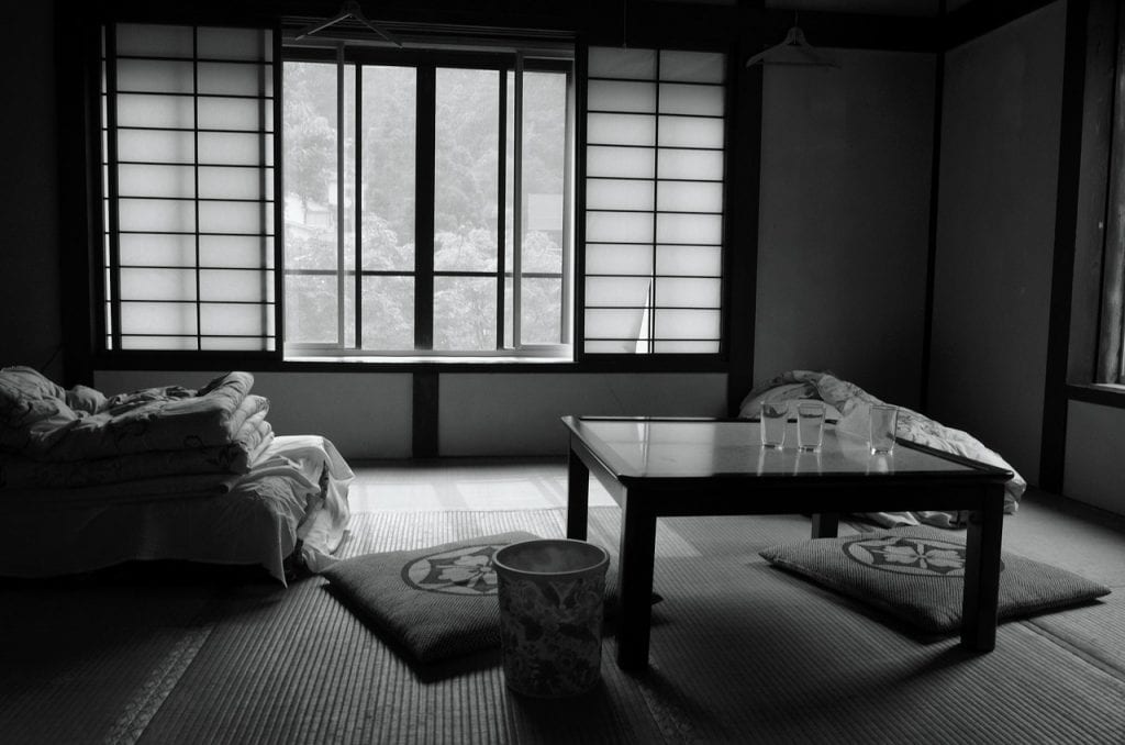 black and white room with a large window and a futon in the corner